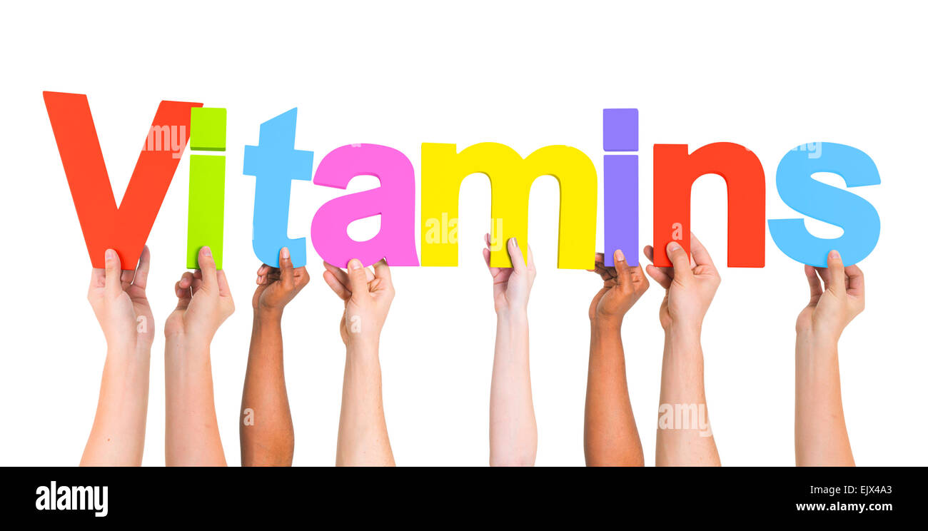 Diverse Hands Holding The Word Vitamins Stock Photo