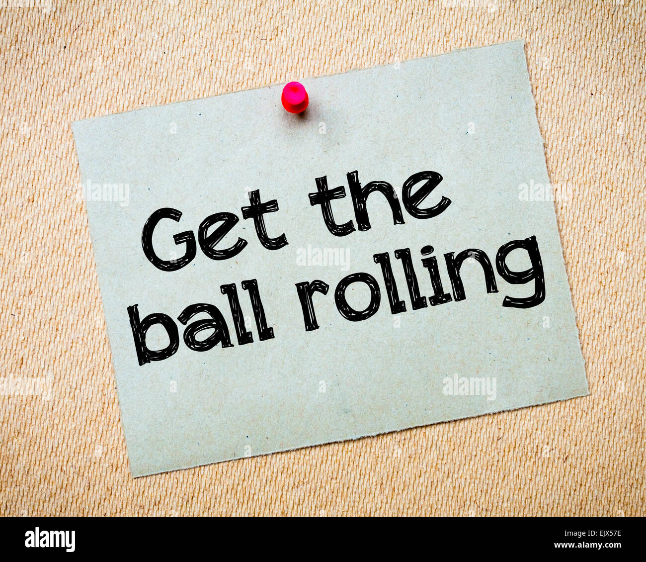 Get the ball rolling Message. Recycled paper note pinned on cork board