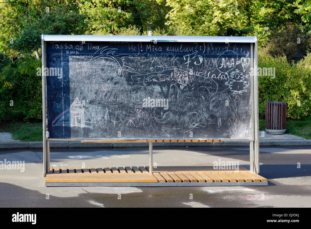 Big public board for drawing by chalk in autumn city park. Summy day
