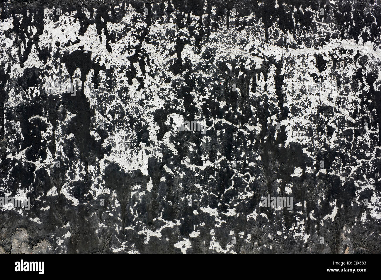 Black spots of bituminous pitch on a concrete wall texture Stock Photo