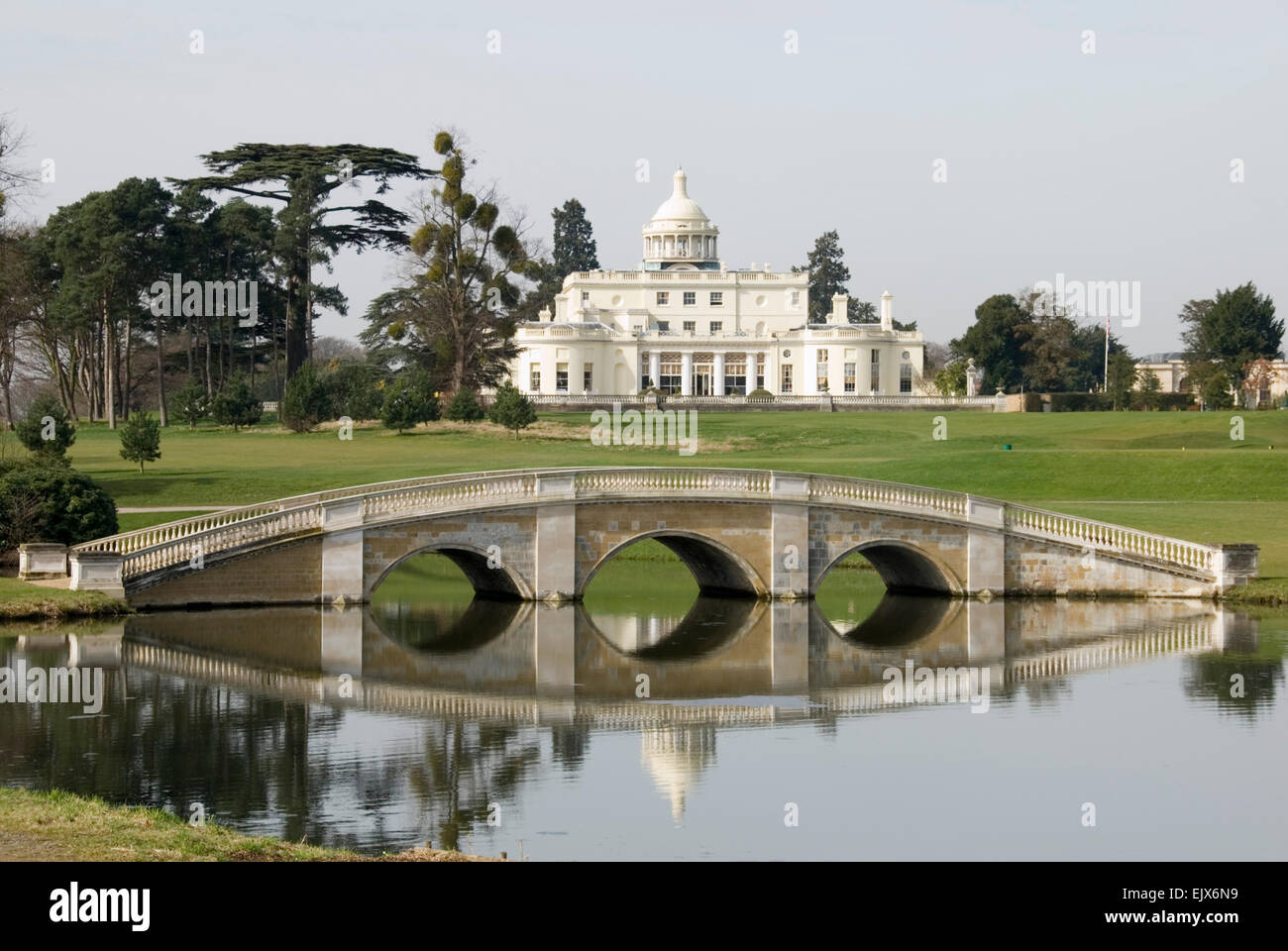 Bucks - Stoke Poges - Stoke Park   - seen across a lake -an elegant bridge sunlight - reflections - now famous hotel + Golf club Stock Photo