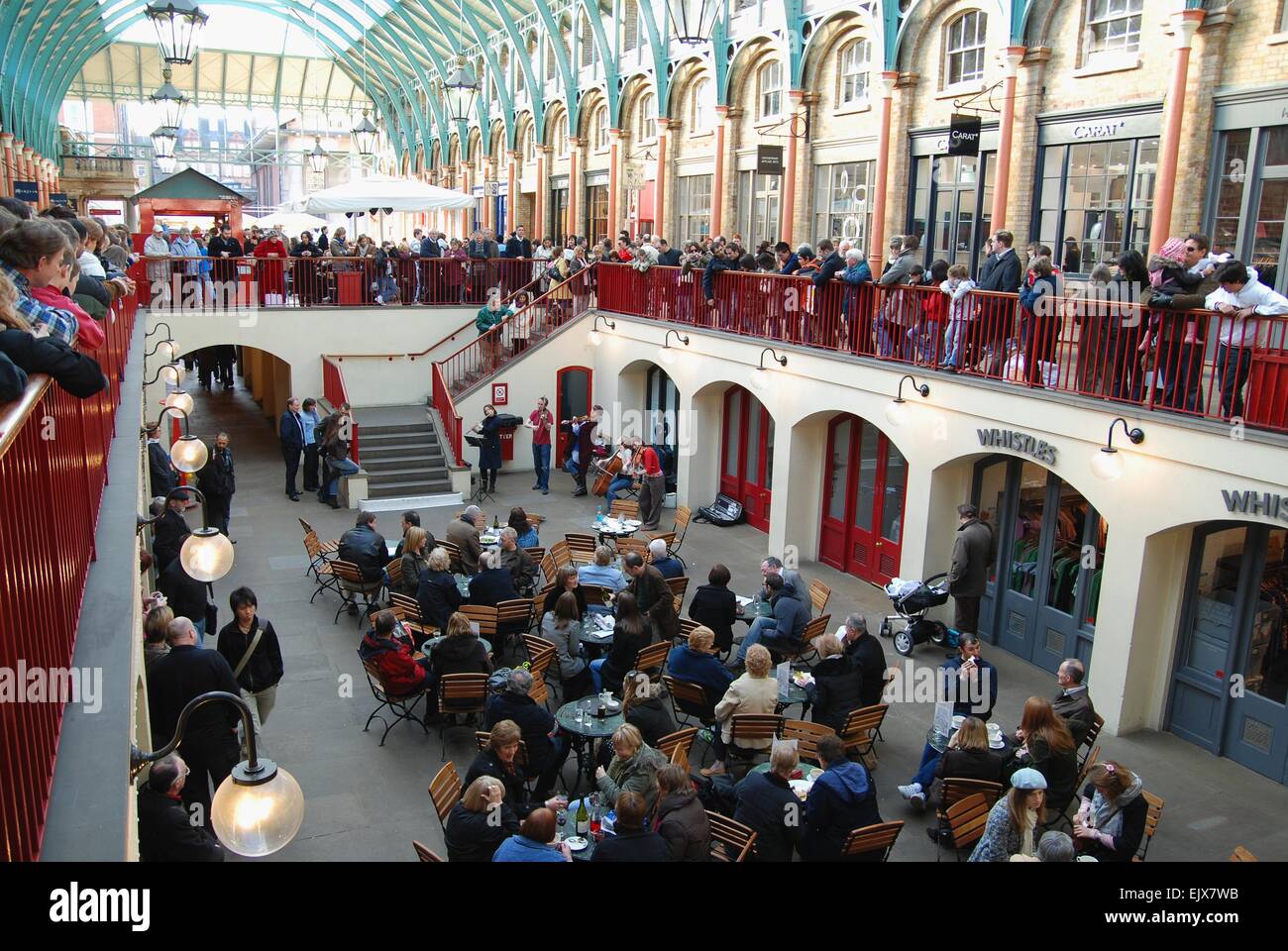 Bustling Covent Garden Indoor Market with a band playing for cafe customers and shoppers, London Stock Photo