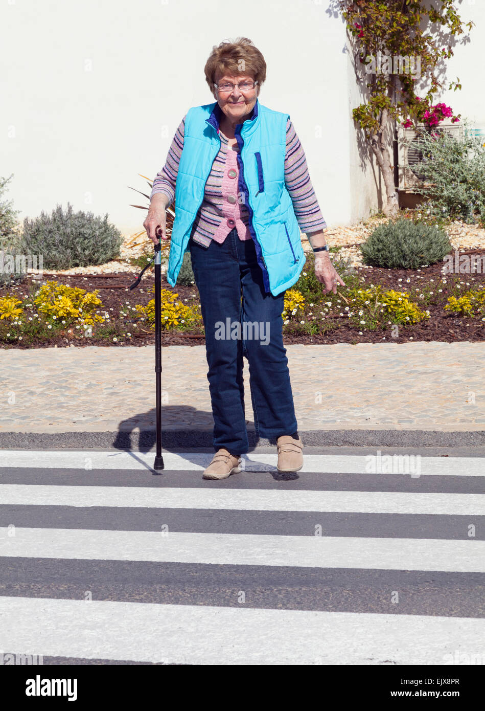 Senior citizen crossing road Stock Photo