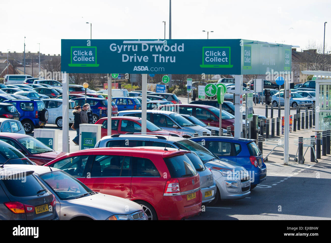 Bilingual welsh english language signage on the 'Drive Thru / Gyrru Drwodd'  click and collect  shop and drive service at the ASDA supermarket, Llanelli town centre, Wales UK Stock Photo