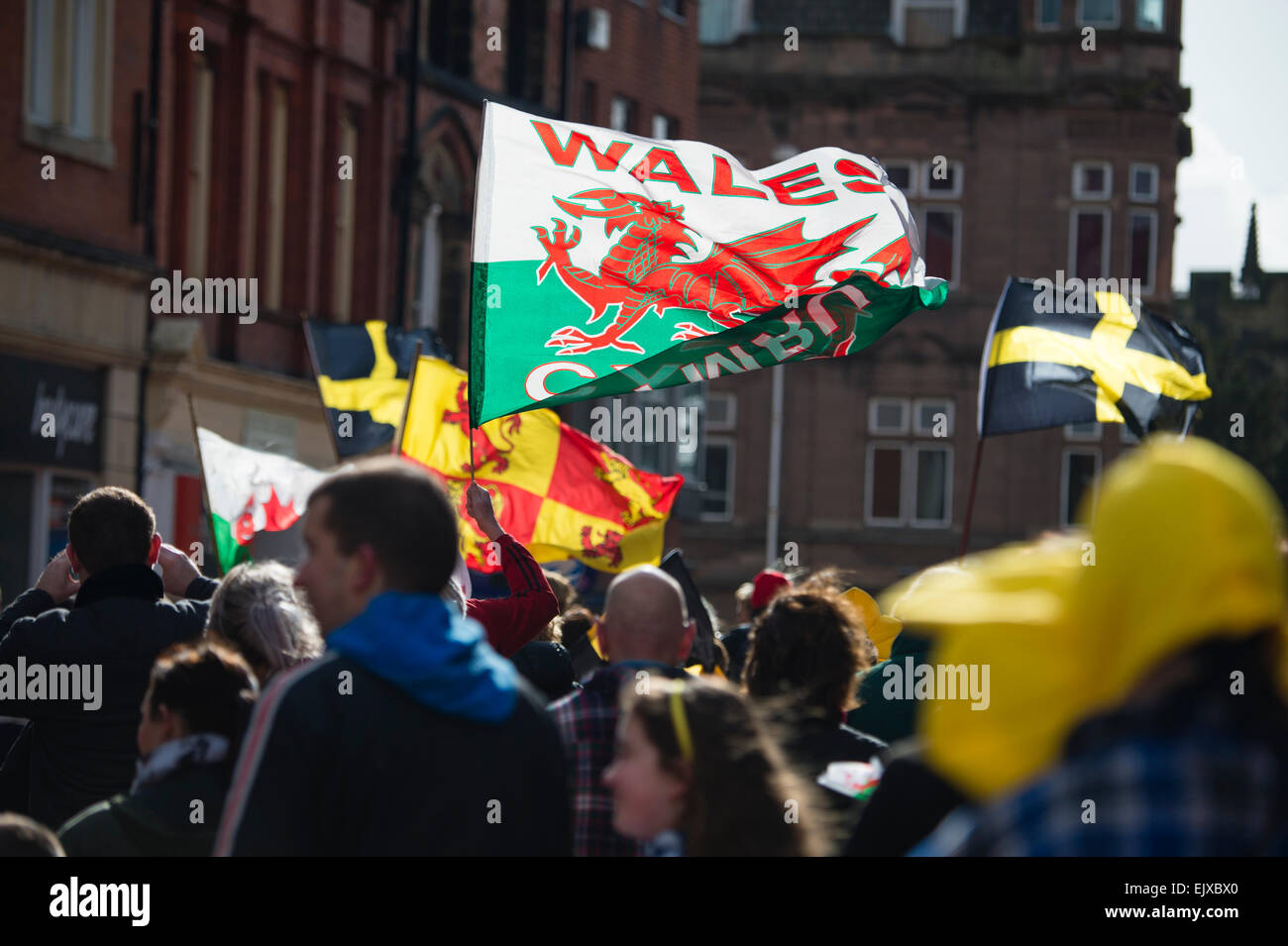 People waving banners and flags taking part in the St David's Day