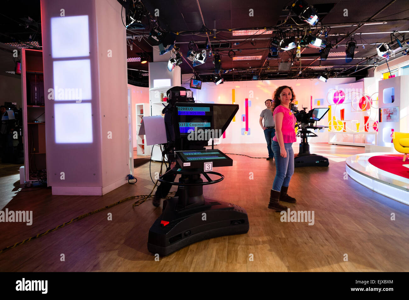 Working in the broadcast media a young woman floor manager and TV