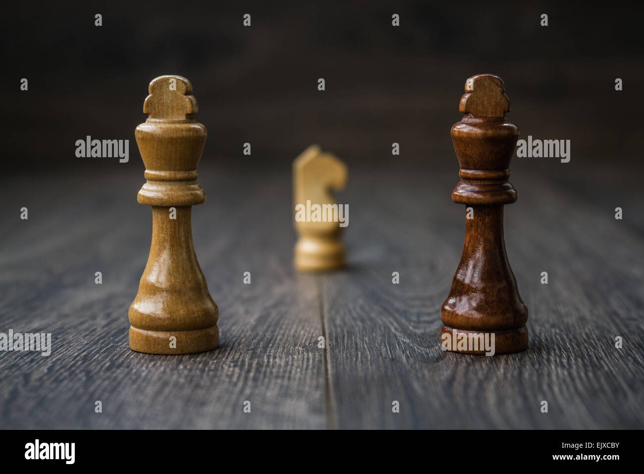 Chess pieces on a brown wooden table and background Stock Photo - Alamy