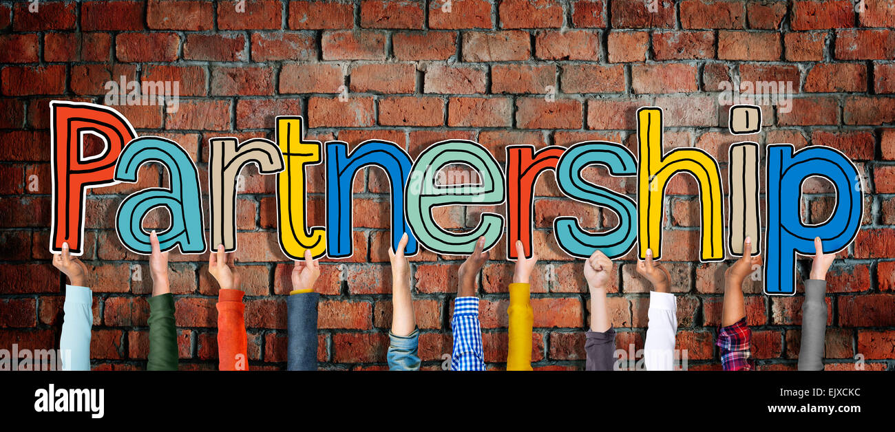 Multi ethnic Group of Hands Holding Word Partnership Stock Photo - Alamy