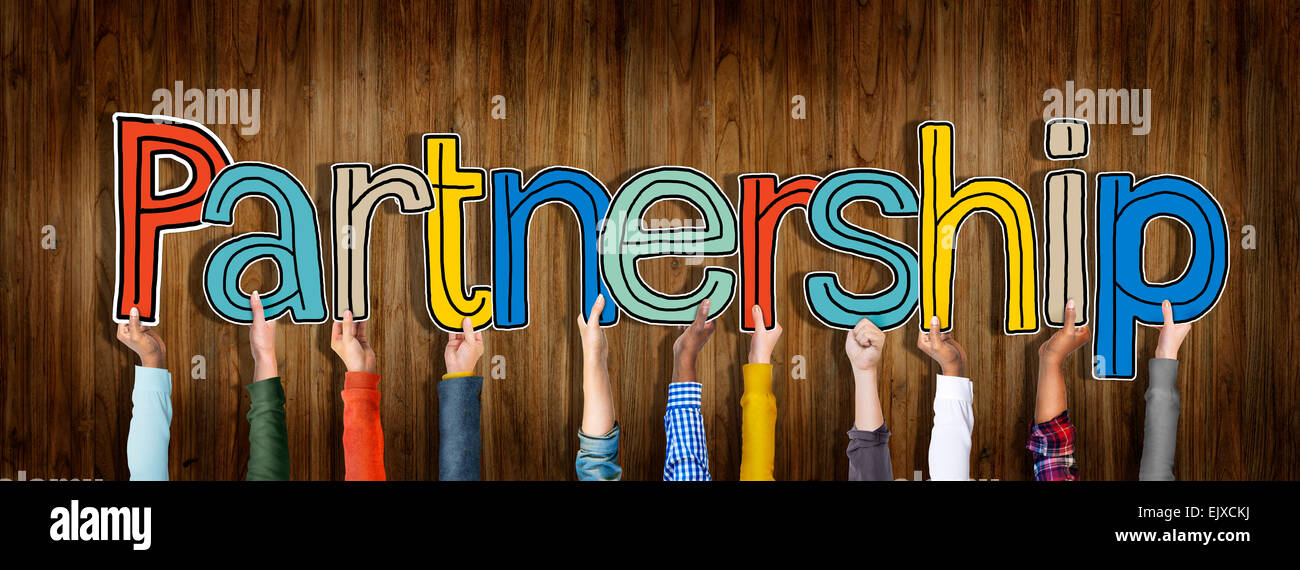 Multi ethnic Group of Hands Holding Word Partnership Stock Photo - Alamy