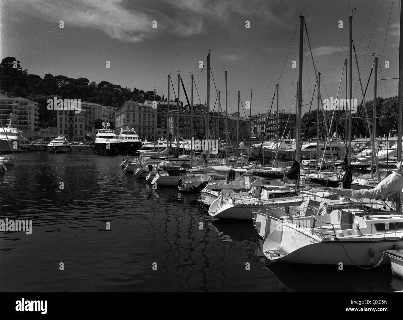 Horizontal medium format monochrome shot of a marina filled with luxury yachts and sail boats. Stock Photo