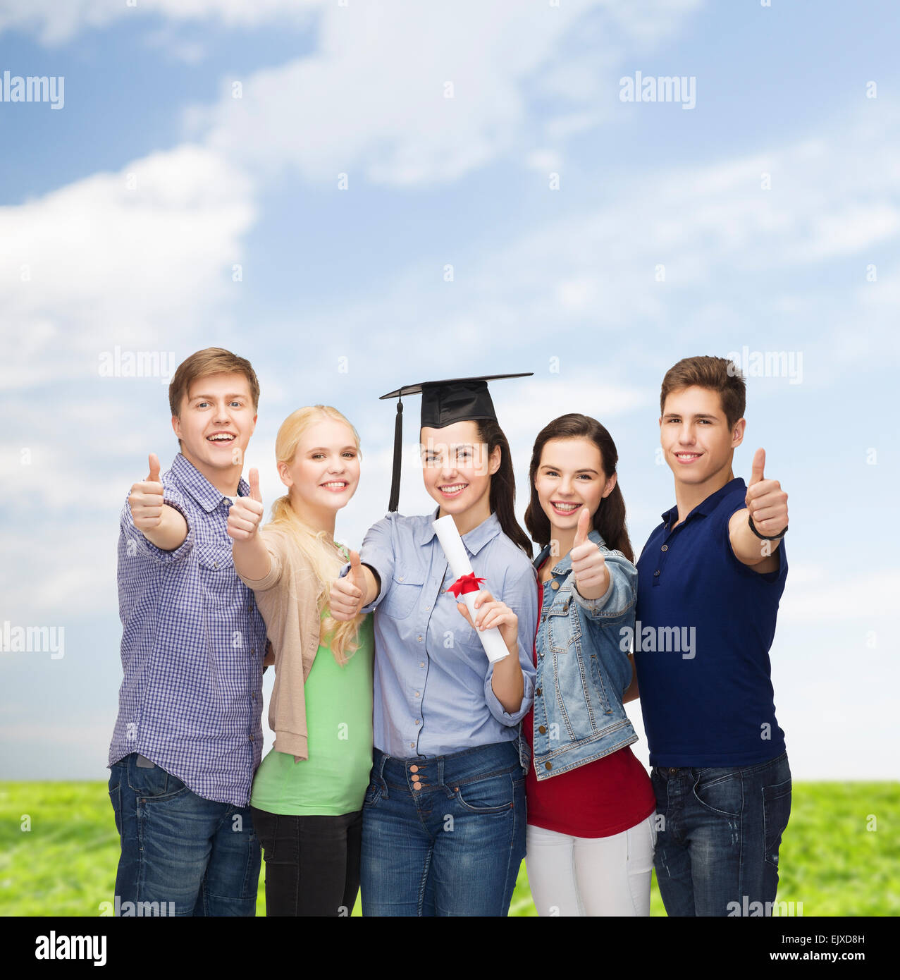 group of students with diploma showing thumbs up Stock Photo - Alamy