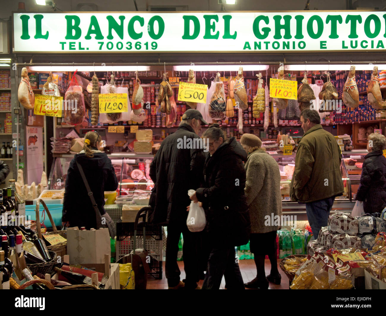 In a covered market in Rome, a store selling hams and cheeses Stock Photo