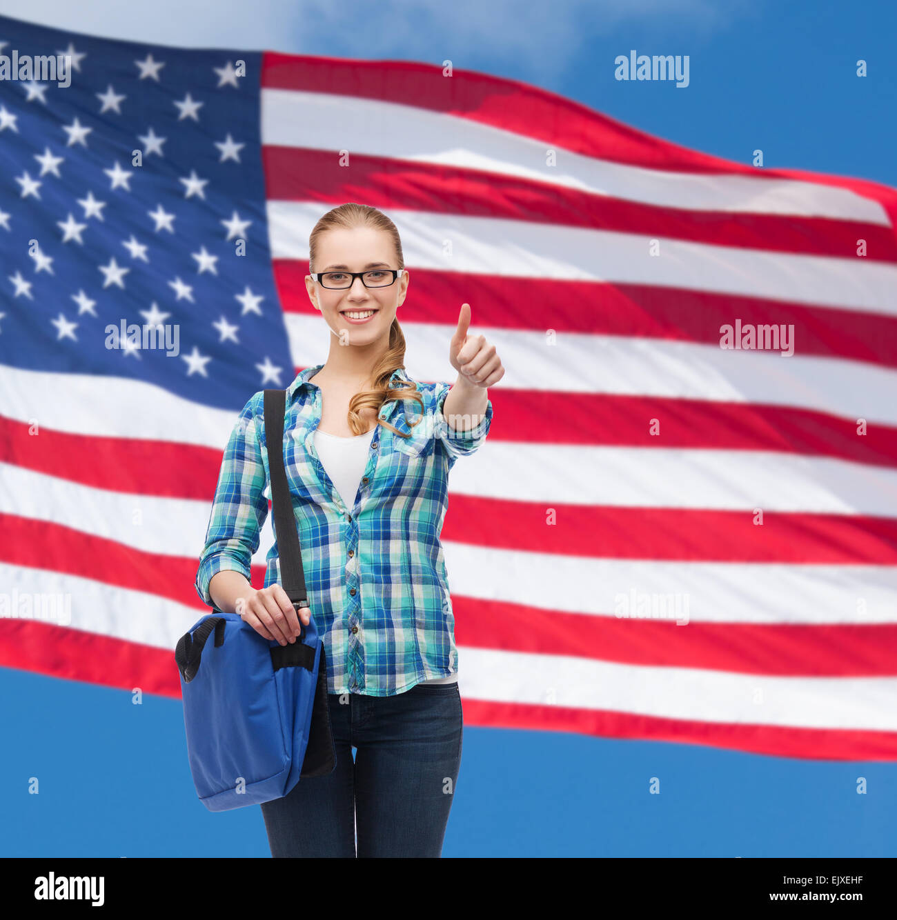 student with laptop bag showing thumbs up Stock Photo - Alamy