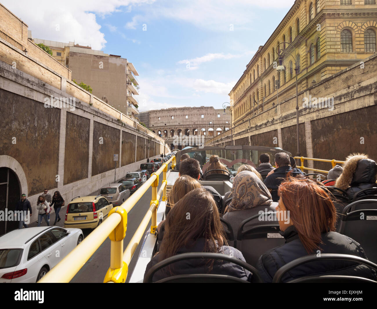 Italy, Rome, Tourists doing sightseeing tour in tour bus, passing Colosseum Stock Photo
