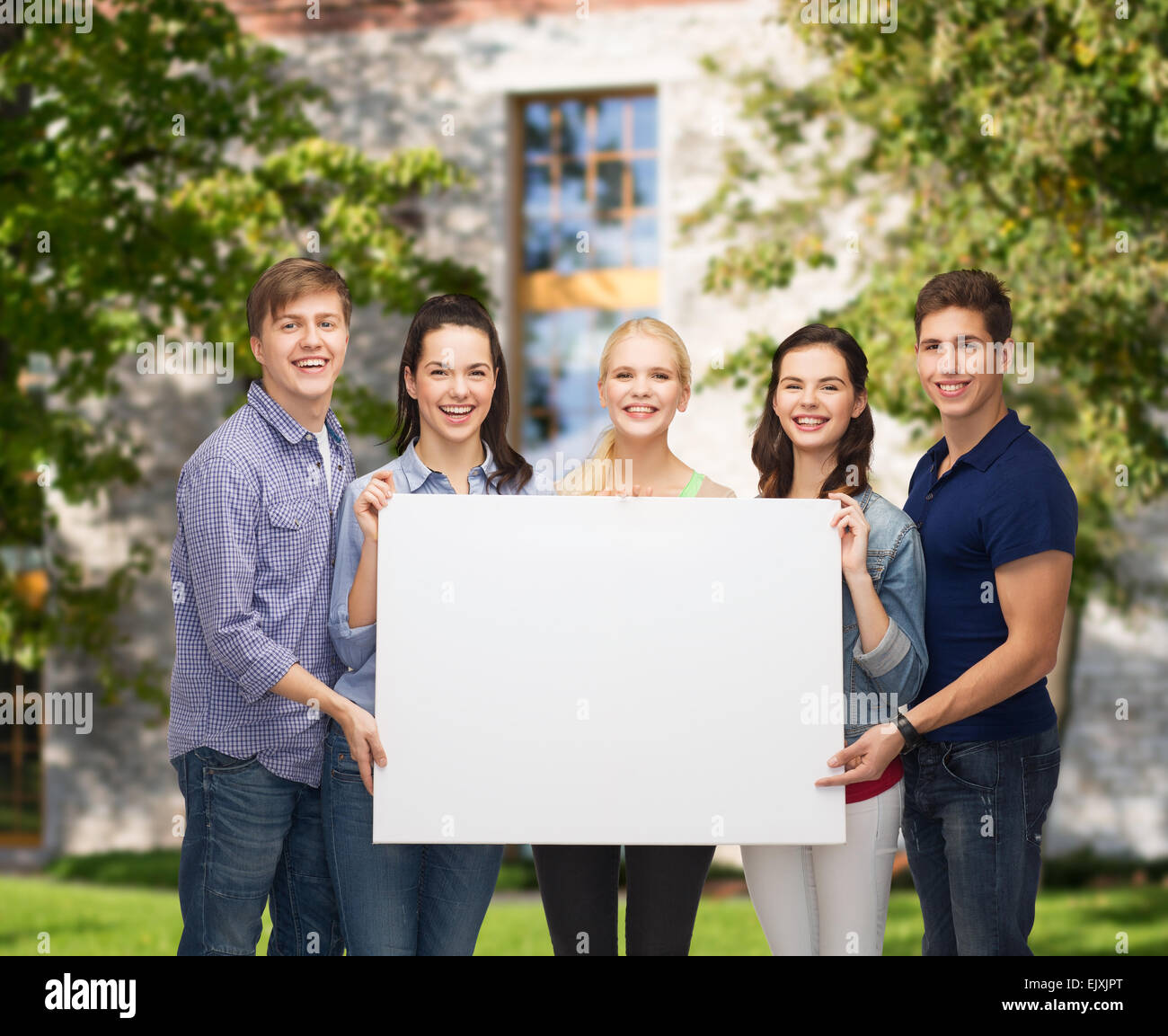 group of standing students with blank white board Stock Photo - Alamy
