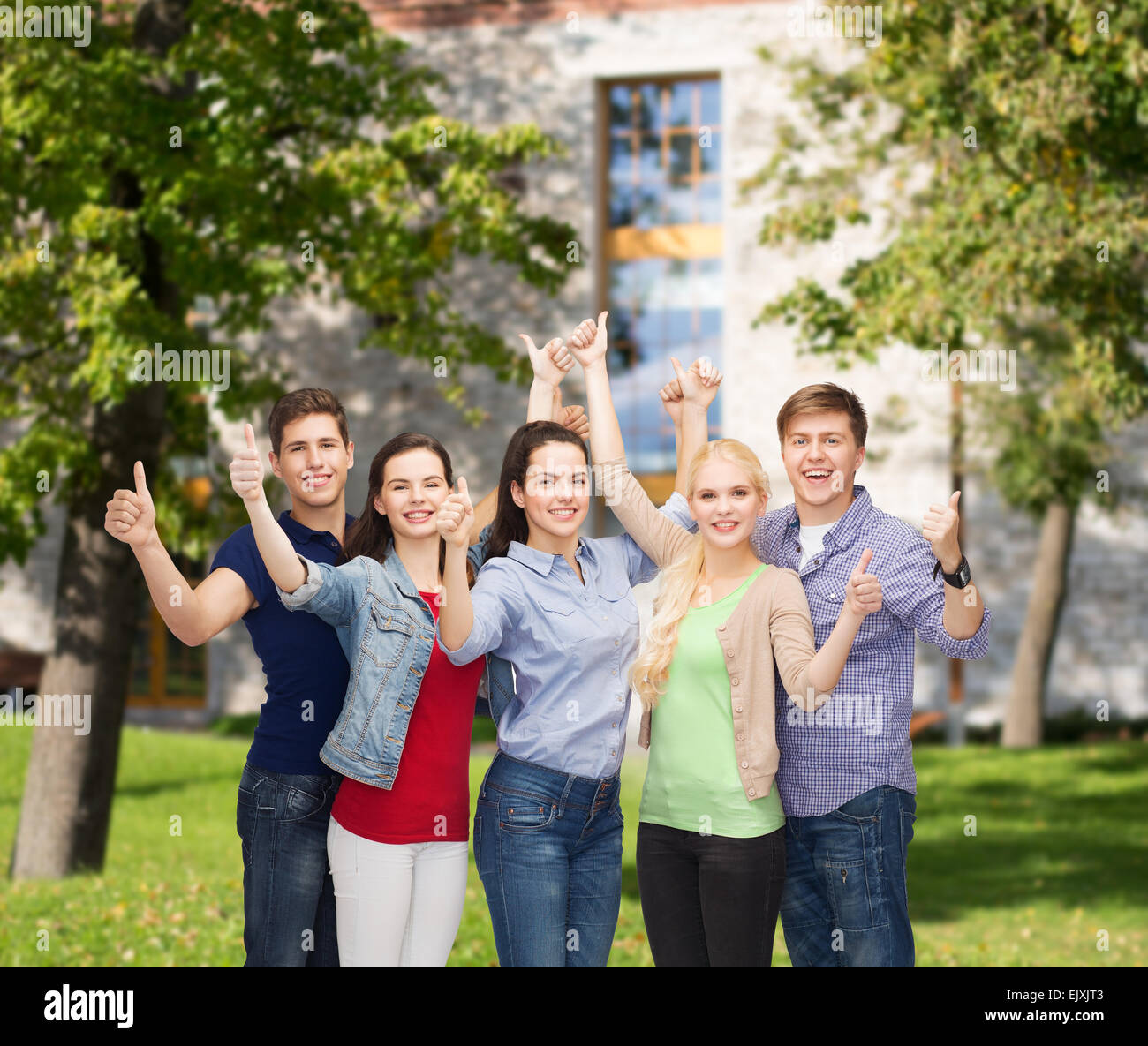 group of smiling students showing thumbs up Stock Photo - Alamy
