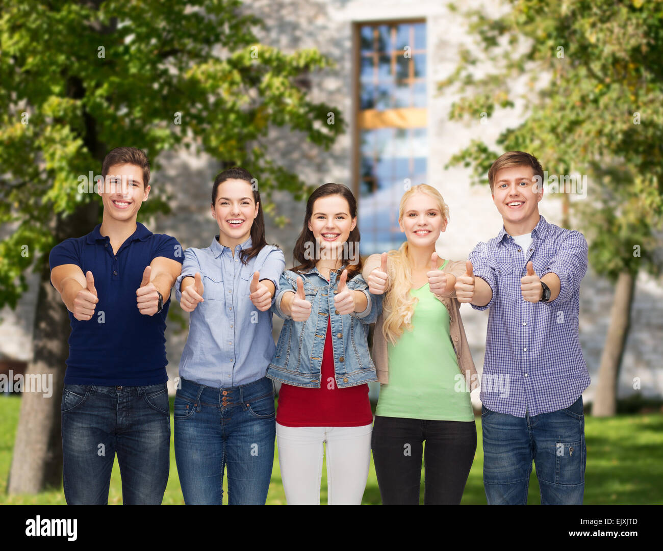 group of smiling students showing thumbs up Stock Photo - Alamy