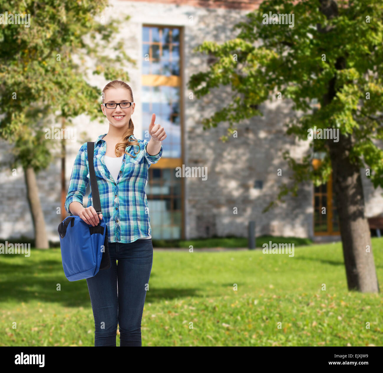 student with laptop bag showing thumbs up Stock Photo - Alamy