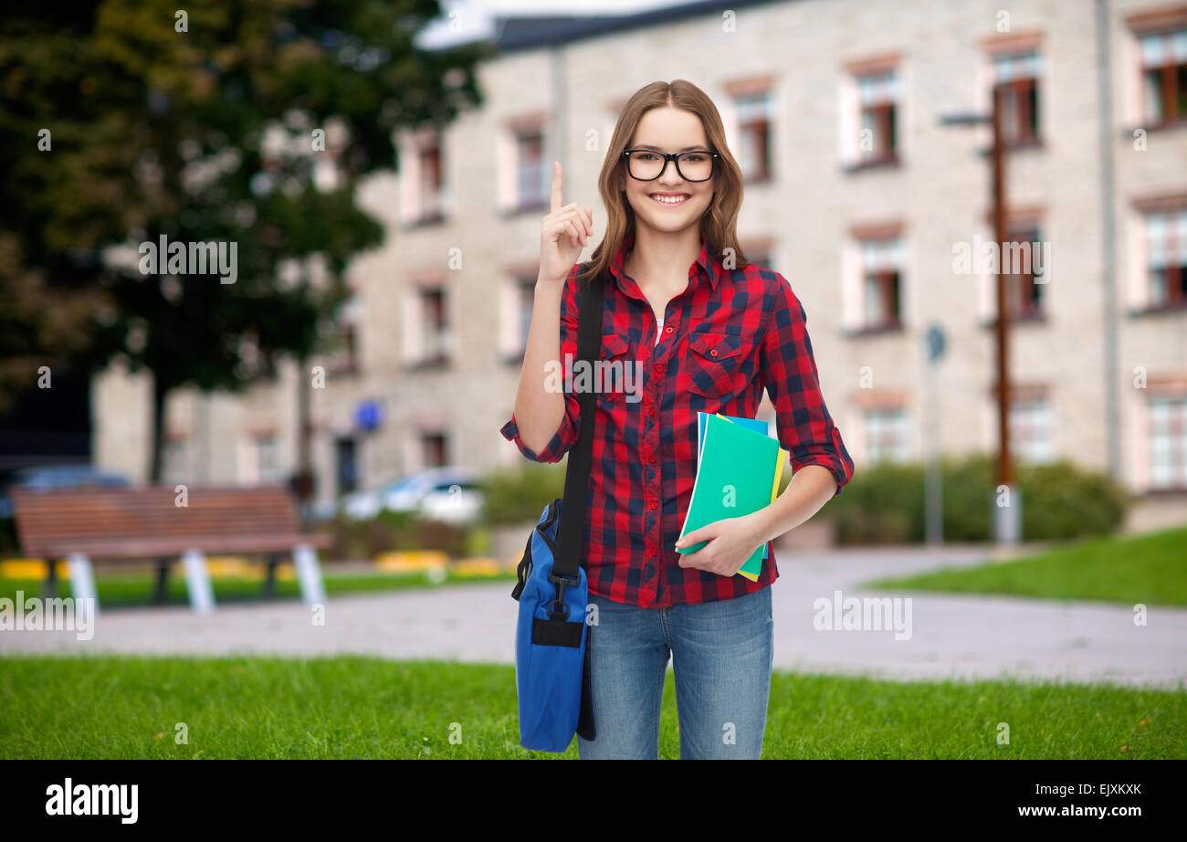 smiling female student with bag and notebooks Stock Photo - Alamy