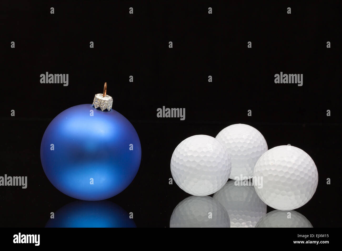 Blue Christmas decoration a golf balls on a black glass desk Stock Photo