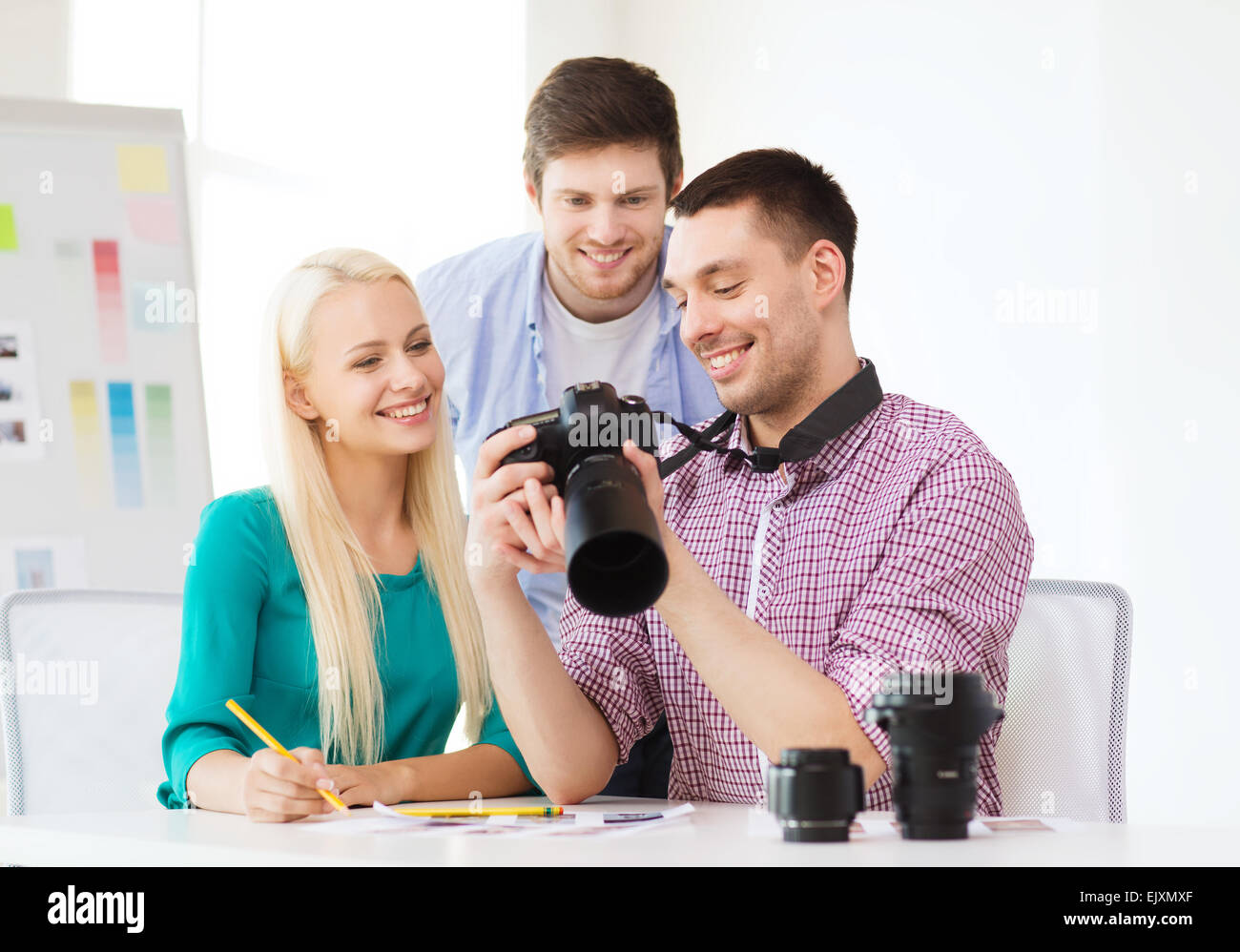 Team Photo Camera smiling team with photocamera working in office Stock Photo - Alamy