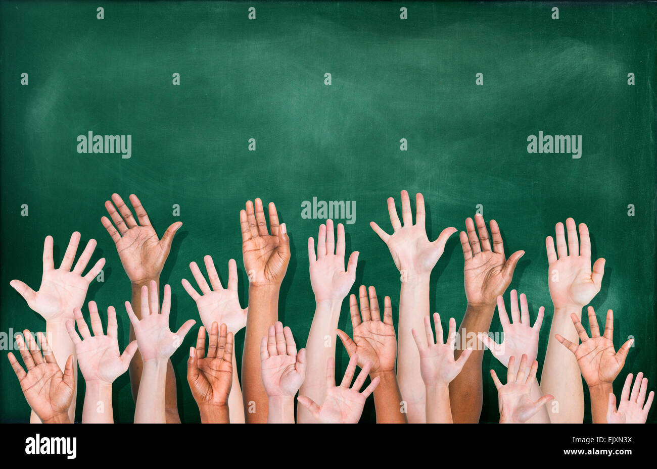 Multiethnic Group of Hands Raised with Blackboard Stock Photo