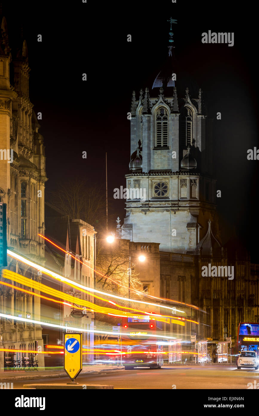 Tom Tower of Christ Church College, Oxford University, viewed down St Aldate's at night as traffic passes by Stock Photo