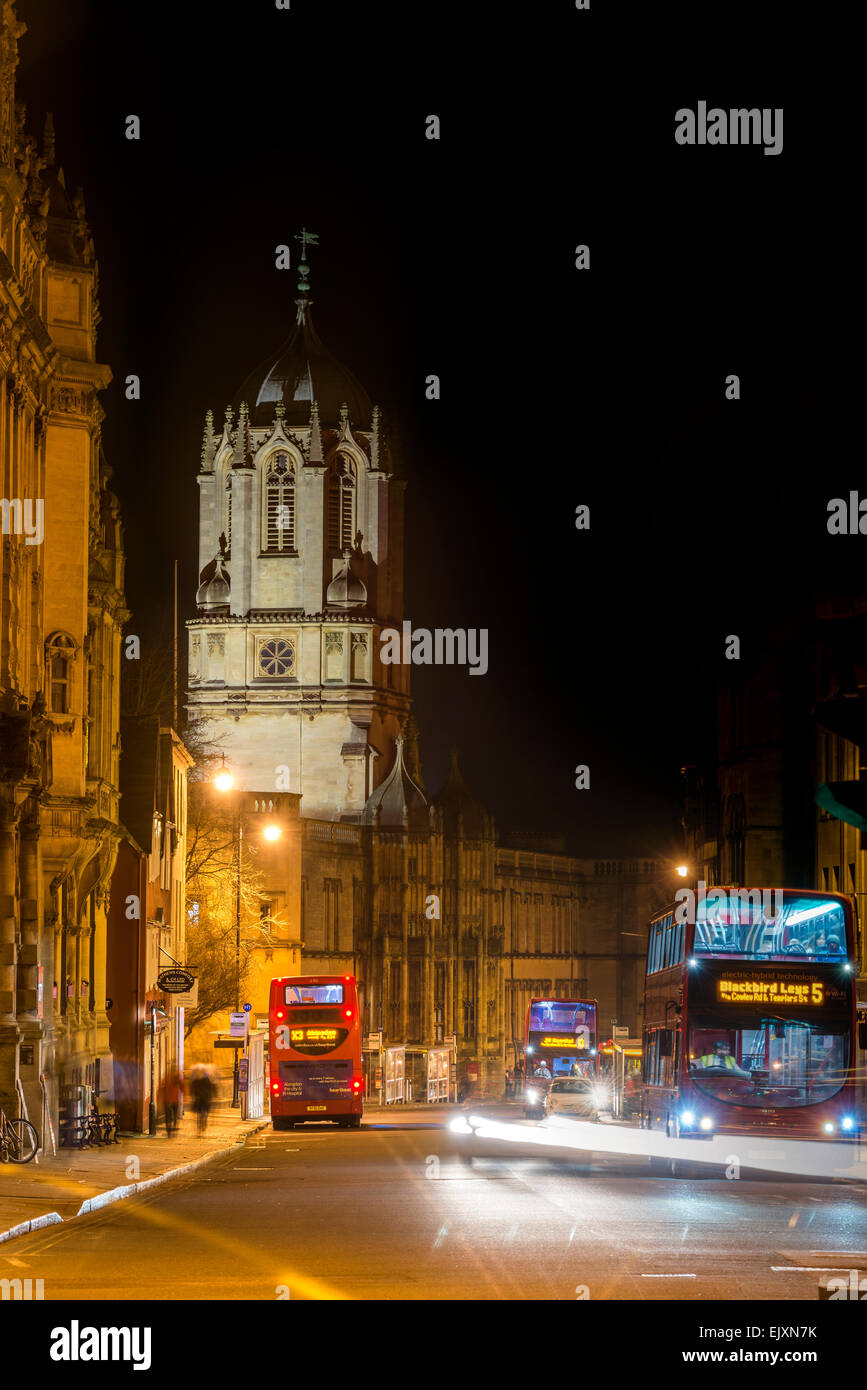 Tom Tower of Christ Church College, Oxford University, viewed down St Aldate's at night as traffic passes by Stock Photo