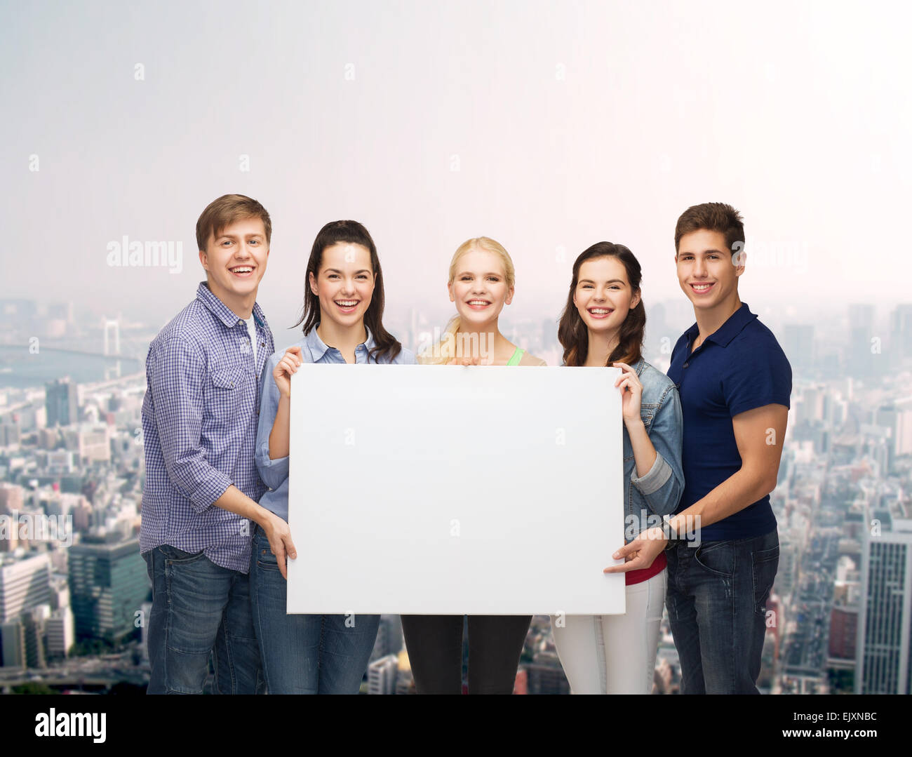 group of standing students with blank white board Stock Photo - Alamy