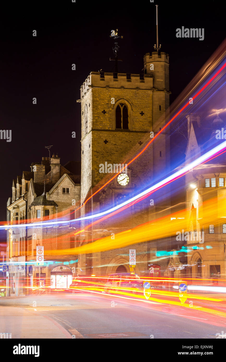 Carfax Tower is an historic tower and considered to mark the city centre of Oxford, UK. Seen at night as traffic passes by. Stock Photo