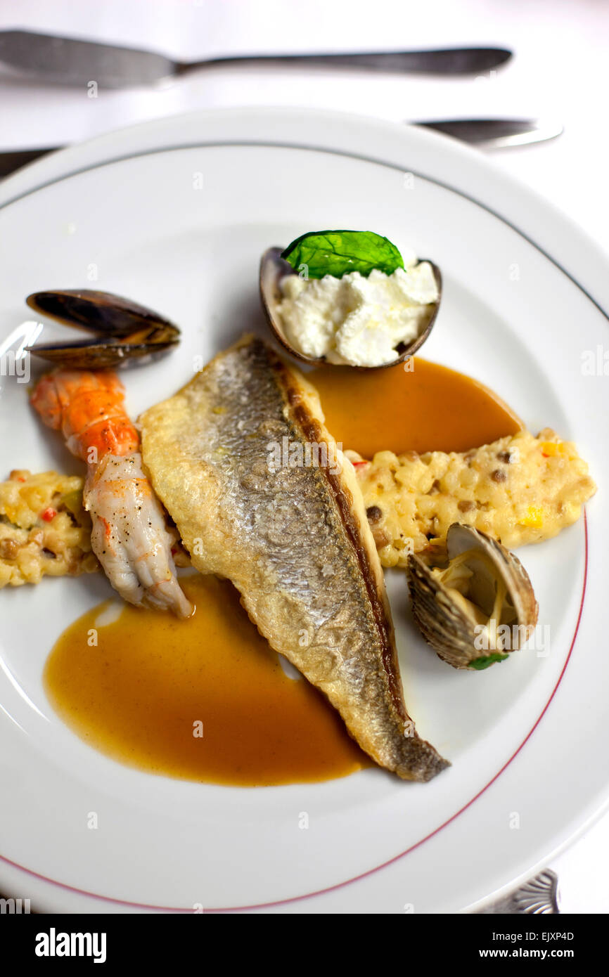 Fish, cereals, langoustine and shells on a plate Stock Photo Alamy