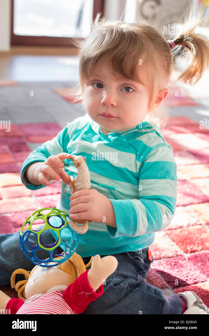 Little girl with toys Stock Photo Alamy