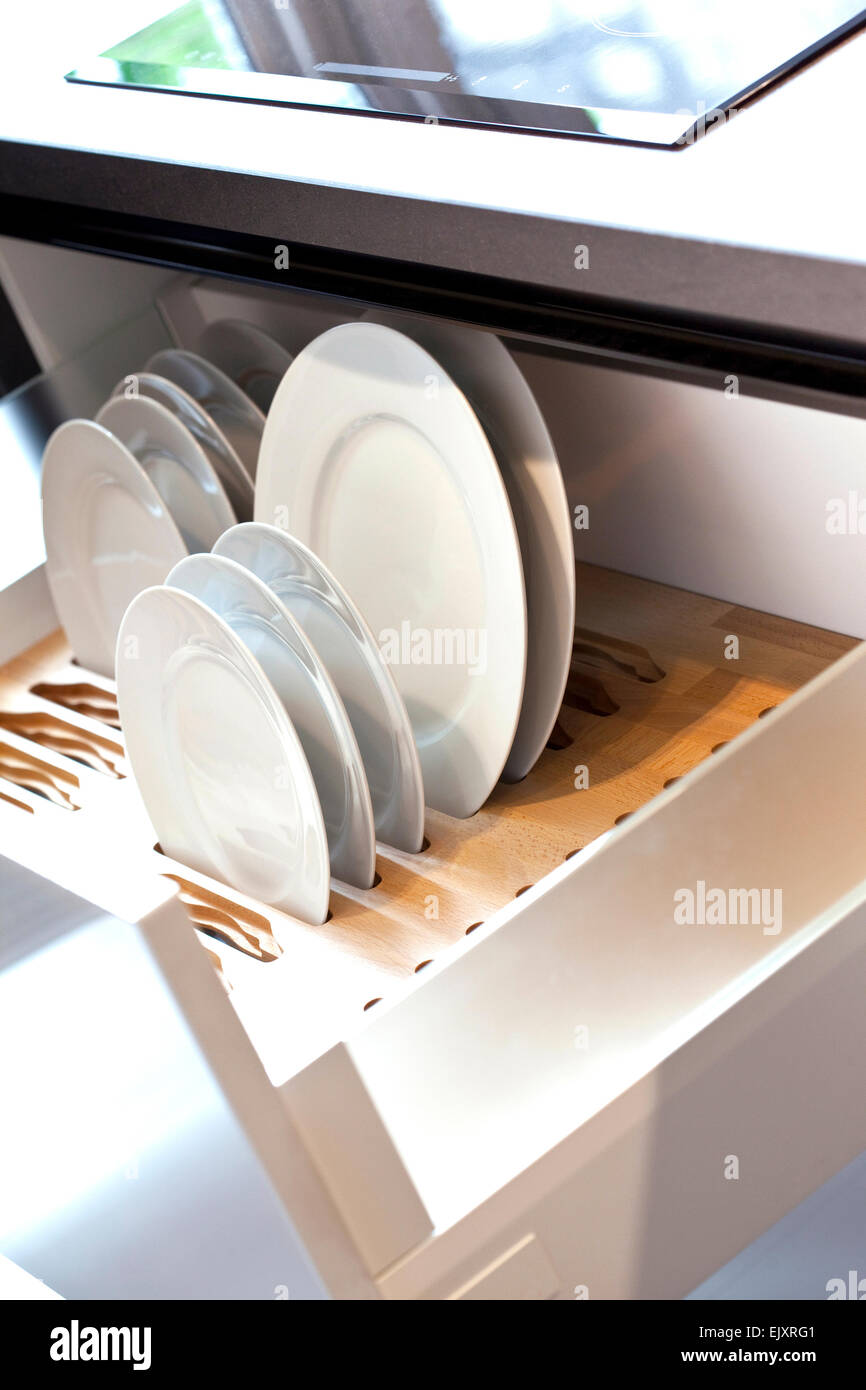 Plates in the drawer of a modern kitchen Stock Photo Alamy
