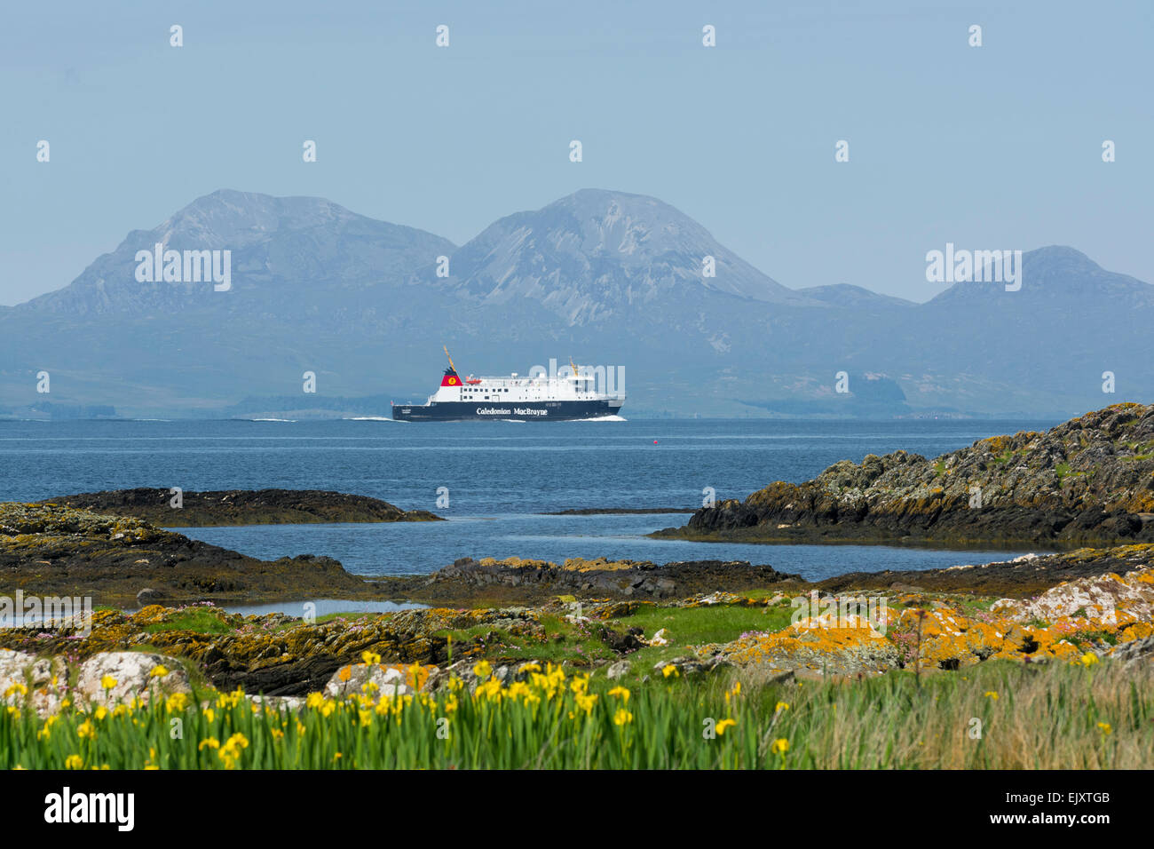 caledonian macbrayne car ferry mv finlaggan from islay en route to kennacraig viewed from shore on gigha with paps of jura Stock Photo