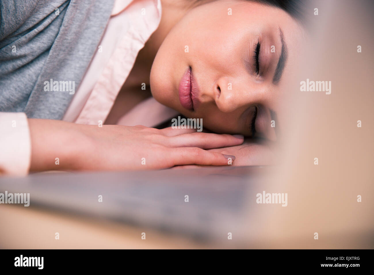 Beautiful business woman sleeping on the table in office Stock Photo