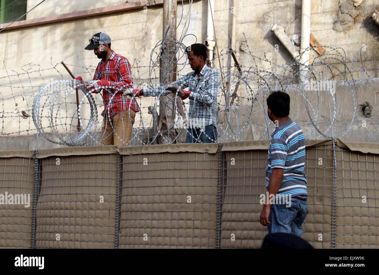 Laborers busy in installing of barbed wires on Sindh Secretariat