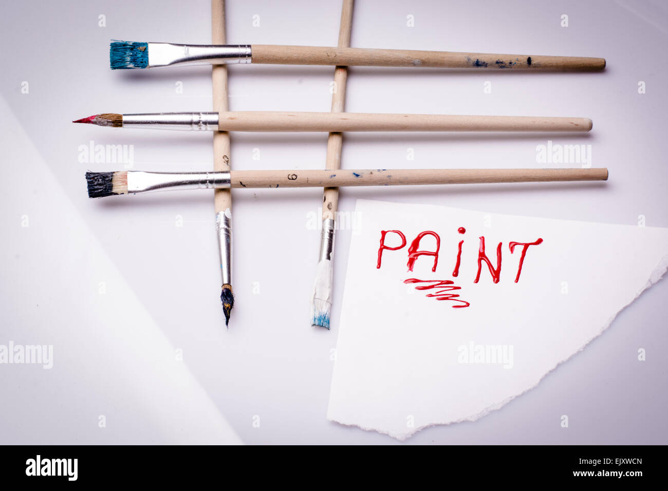 Paint word on a white sheet and paint brushes Stock Photo Alamy