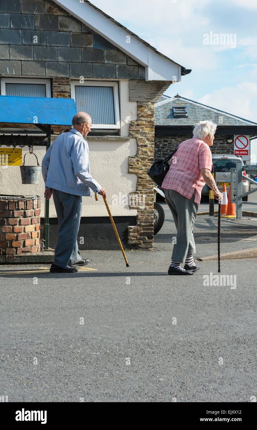 Elderly couple, with walking sticks. Stock Photo