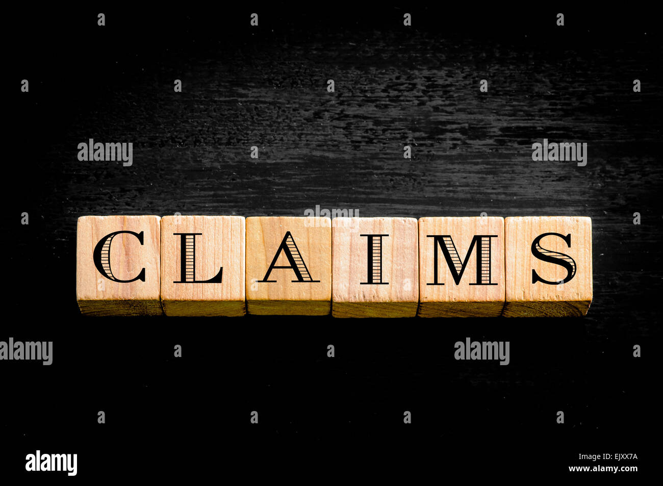 Word Claims. Wooden small cubes with letters isolated on black ...