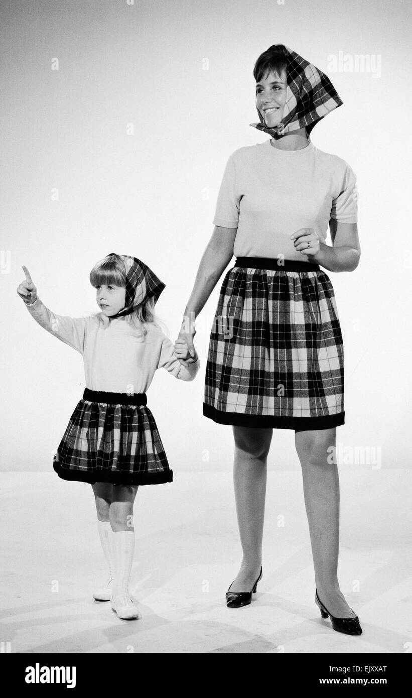 Plaid skirt fashion shoo. Mother and daughter in matching check skirts ...