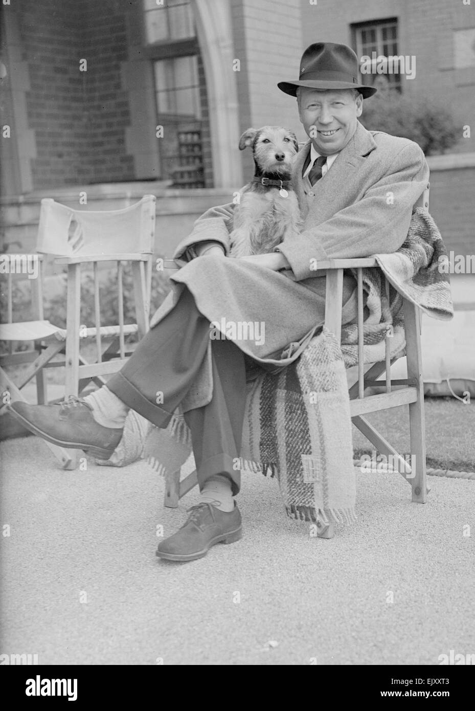 Entertainer George Formby seen here with with his dog at Lytham St Anne's 22nd March 1953 Stock Photo