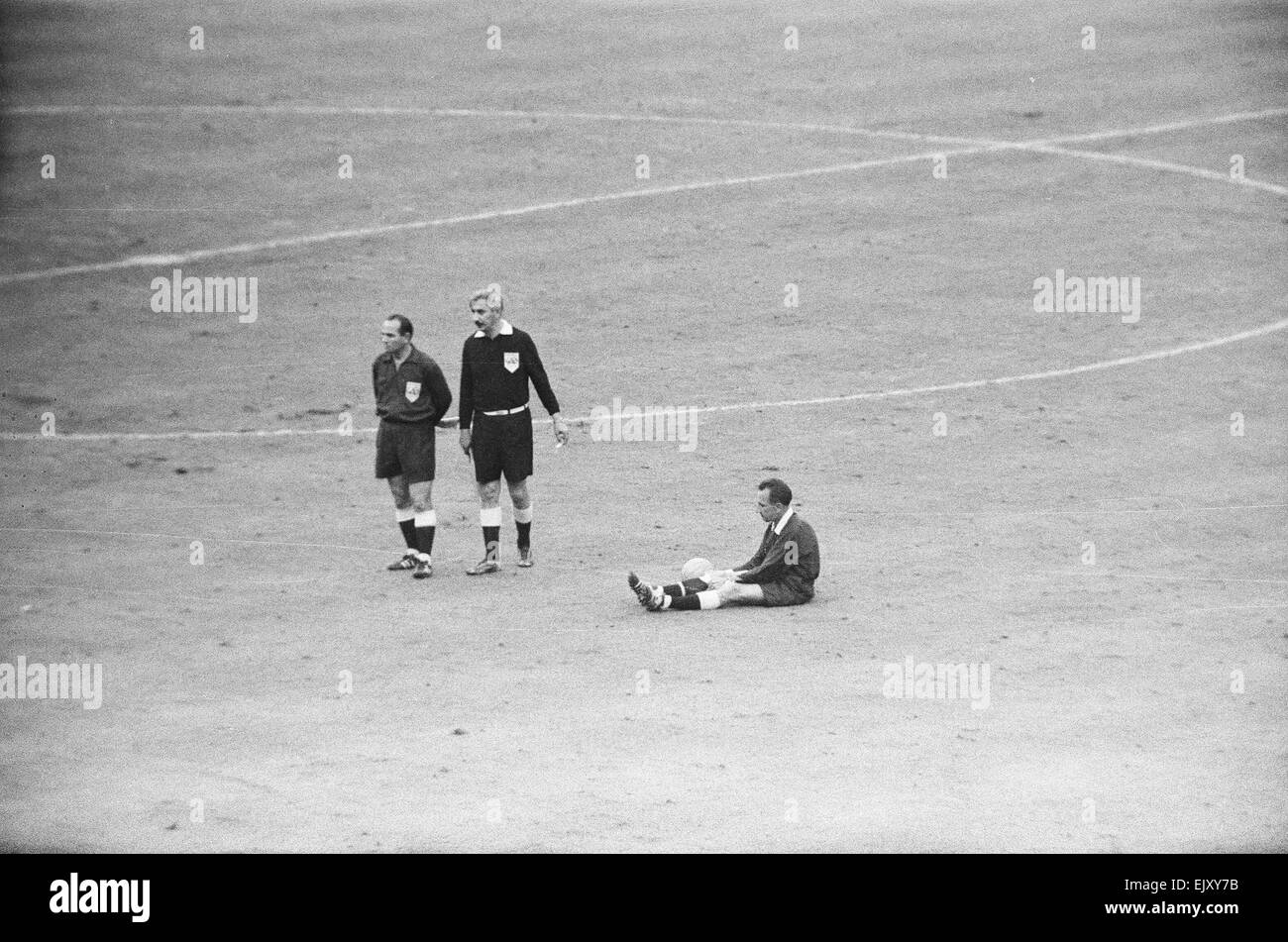 England v West Germany World Cup Final 1999, 30th July 1966.  The officials were also feeling the strain. Dienst took a well-earned rest, while linesman Karol Galba (left) and in particular Tofik Bakhramov (centre) readied themselves for what would be the most dramatic of contributions to subsequent events.  Final Score:  England 4-2 West Germany A.E.T. *** Local Caption *** England v West Germany World Cup Final 1999, 30th July 1966.  Final Score:  England 4-2 West Germany A.E.T. Stock Photo