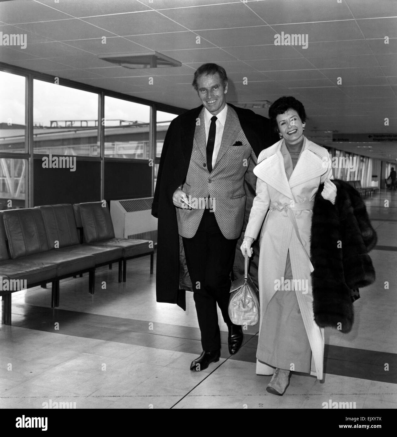 Charlton Heston, and his wife Lidia leaving London after attending the Premiere of his film 'Anthony and Cleopatra'. Now they are on their way to Japan for the film's premiere over there. March 1972 72-2084-001 Stock Photo