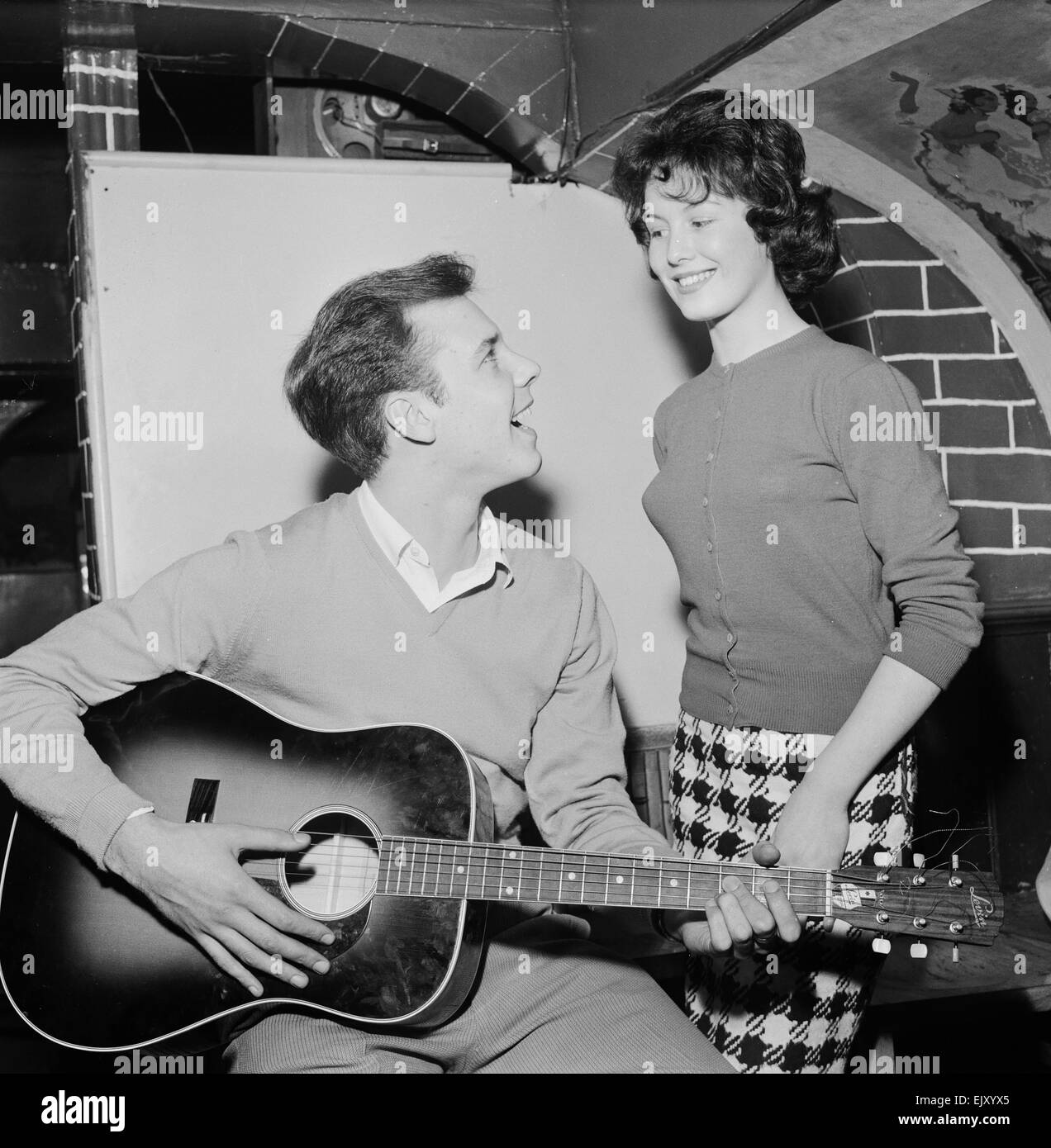 Singer Marty Wilde sings to his fiancee Joyce Baker (18), 28th October 1959. Stock Photo