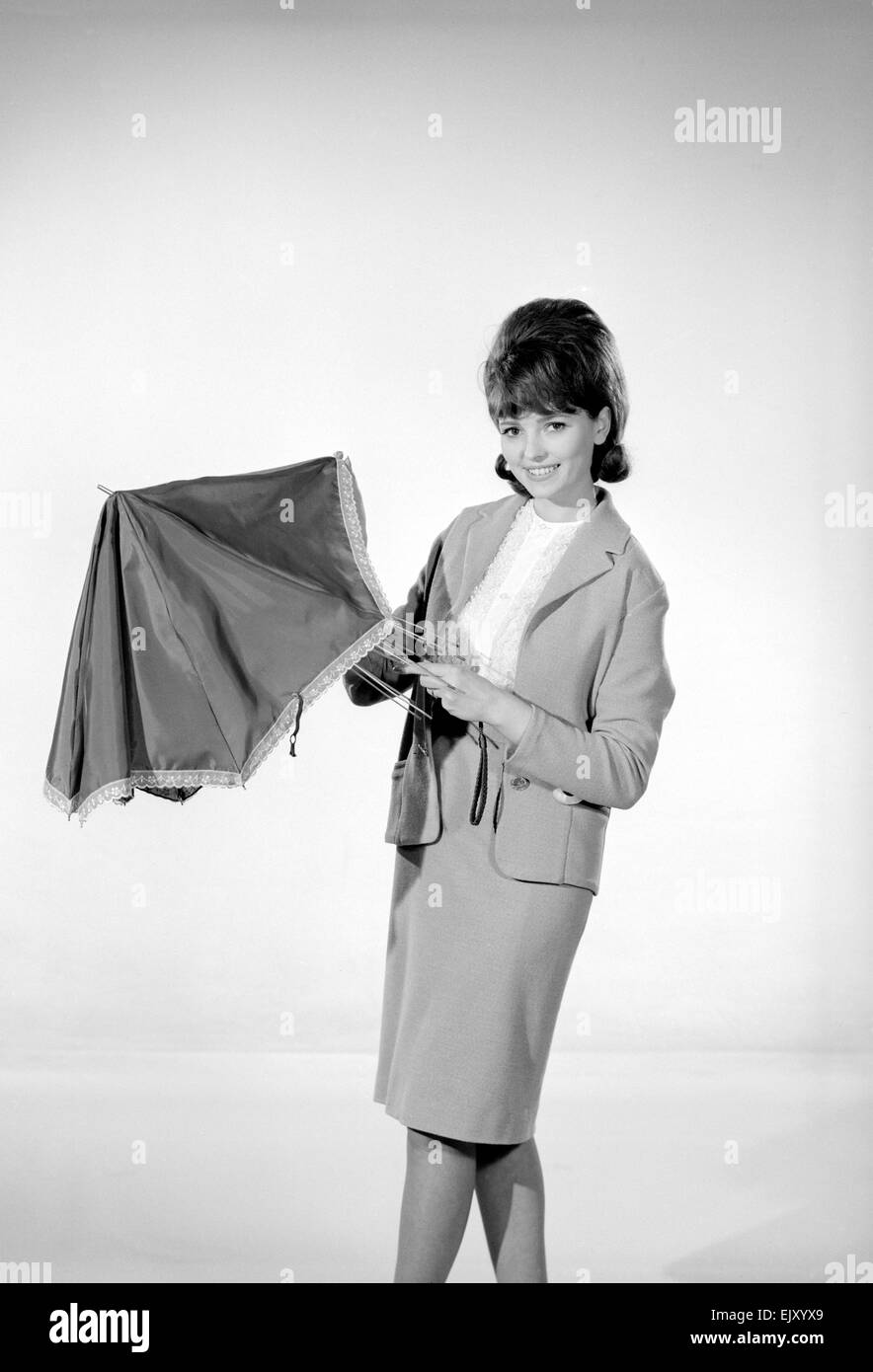 Reveille Fashion Feature  Reveille Model M Walden seen here with an umbrella. December 1963 Stock Photo