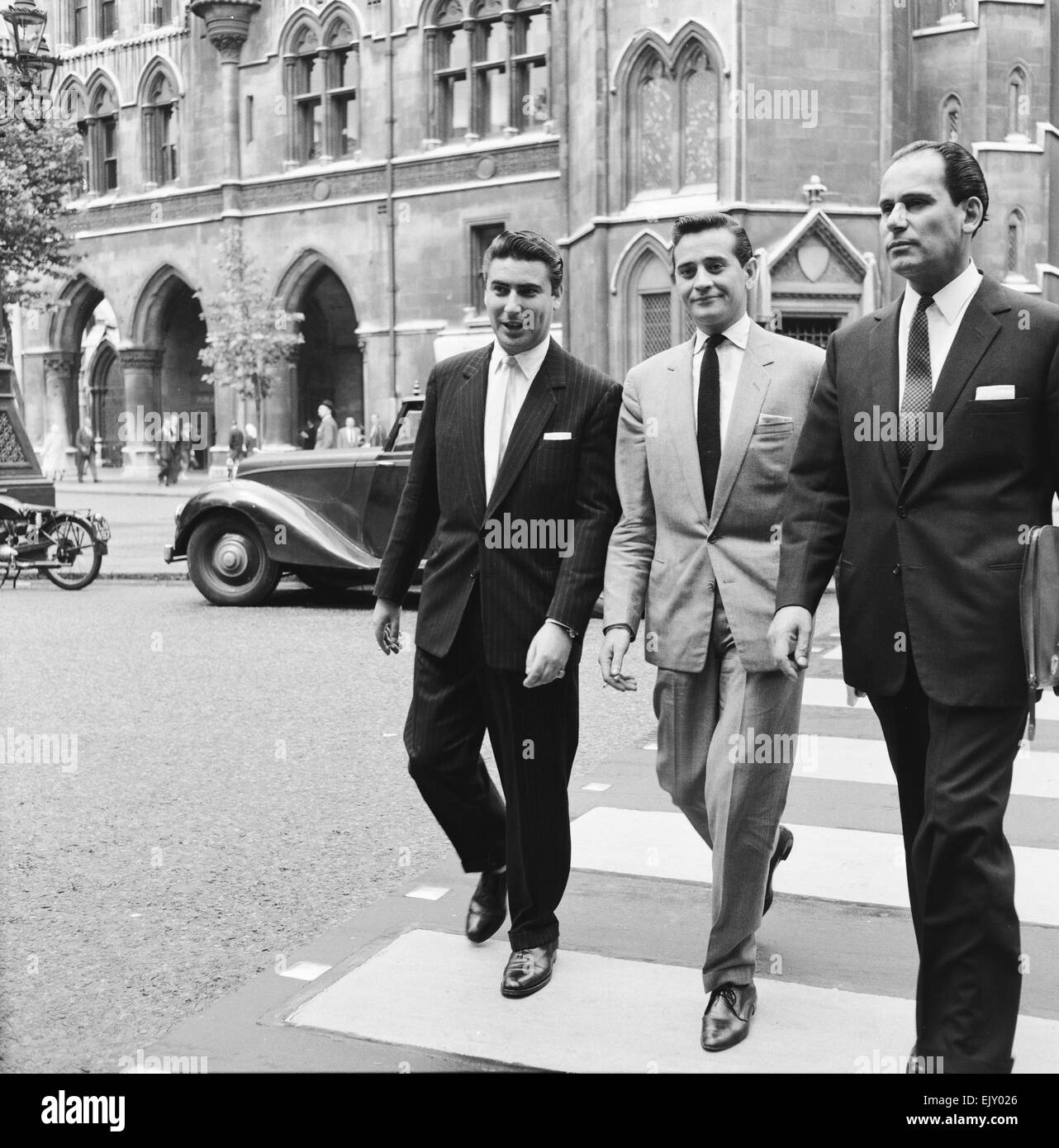Larry Parnes (left) & John Kennedy (centre), managers of singer Tommy Steele, pictured arriving at court to attend liable action against a publishing company 7th July 1960. *** Local Caption *** Lawrence Parnes Manager Stock Photo