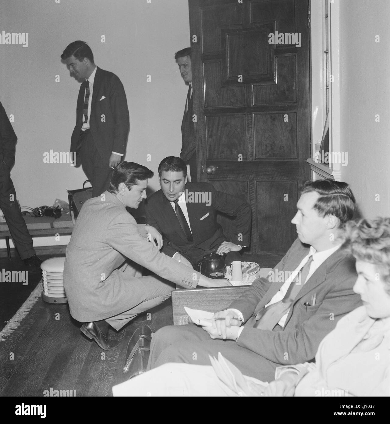 Larry Parnes (centre) and John Kennedy (left), Managers of singer Tommy Steele, crouch down as they enjoy a pot of tea, 28th April 1961. *** Local Caption *** Lawrence Parnes Manager Stock Photo
