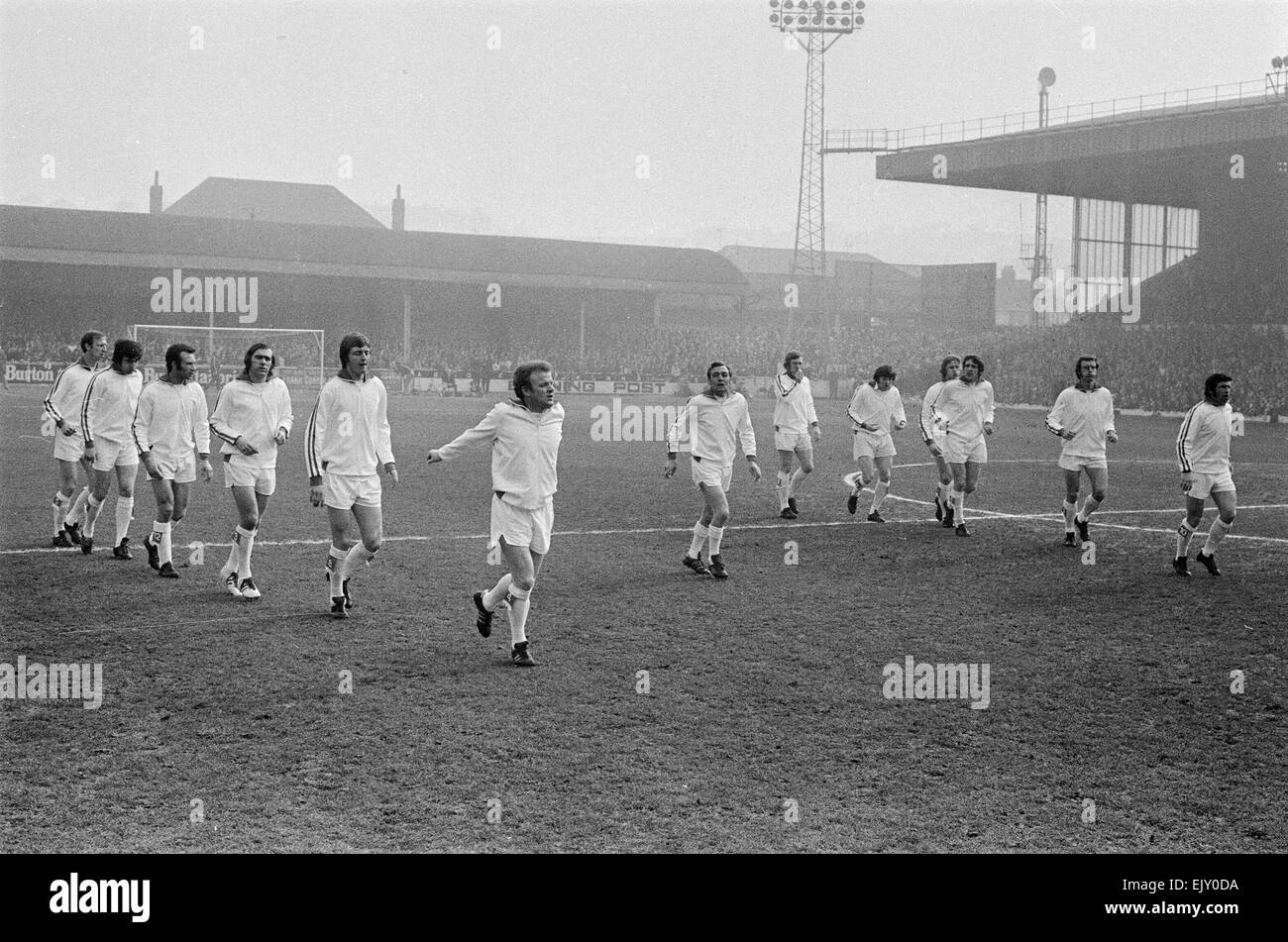 FA Cup Quarter Final match at Elland Road. Leeds United 2 v Tottenham Hotspur 1. The Leeds team led by their manager Les Cocker and captain Billy Bremner warm up on the pitch before kick off. 18th March 1972. Stock Photo