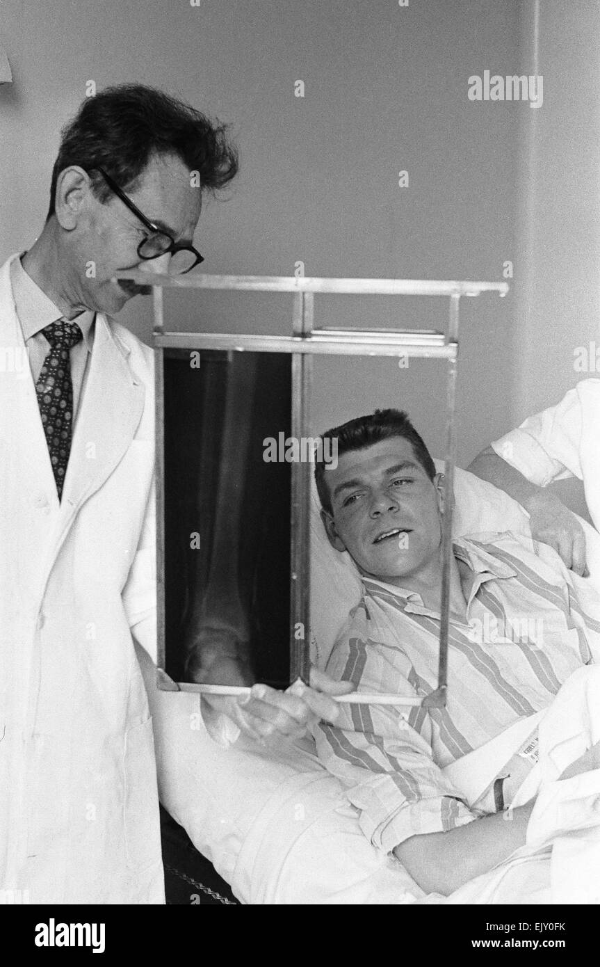 FA Cup Final at Wembley Stadium. Wolverhampton Wanderers 3 v Blackburn Rovers 0. Injured Blackburn full back Dave Whelan, whose legs was fractured in a challenge with Wolves Norman Deeley, is shown an xray of his fracture by a doctor in hospital.   7th May 1960. Stock Photo