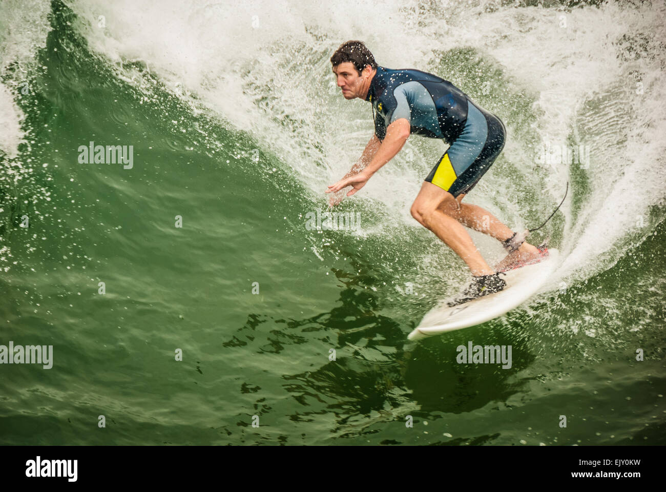 Surfer slicing across the face of a large wave at Manhattan Beach in Los Angeles County, California, USA. Stock Photo